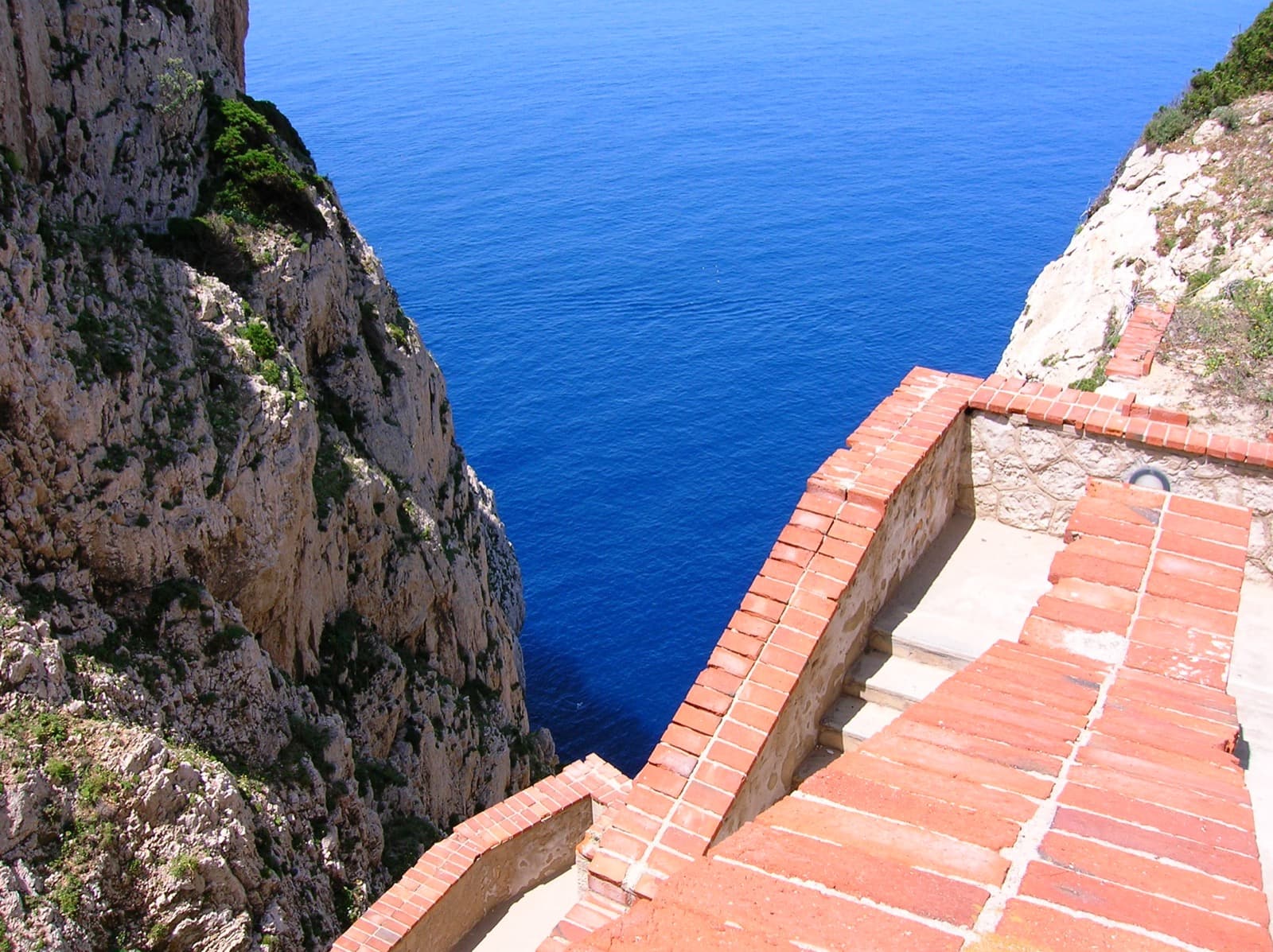 The Escala del Cabirol staircase descending to the Grotte di Nettuno at the sea's edge